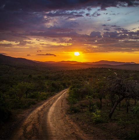 A dark road with the sun coming out