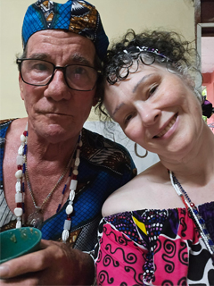 Alo Ocan Roberto Gonzalez Sousa in front of his Orish Altar. Image of Alo Ocan Roberto Gonzalez with Eileen Casey Gonzalez